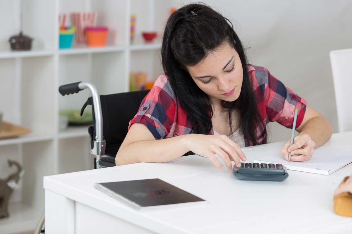 Young person writing at a desk
